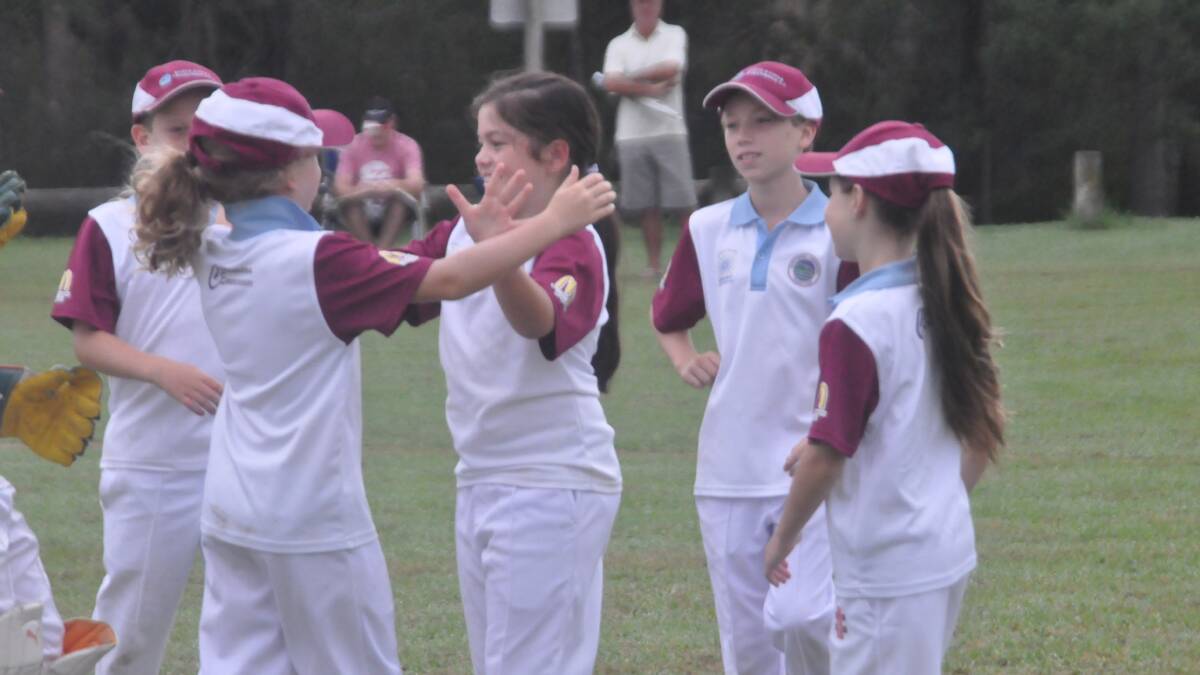 HUGS ALL ROUND: North Nowra-Cambewarra Blues’ Emily Burinaga (centre) goes in for a hug after a wicket in the under 10s grand final on Sunday. 
