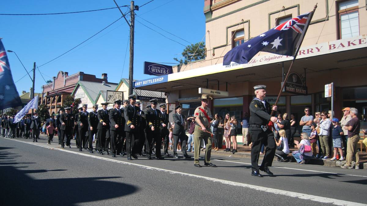 NATIONAL PRIDE: The Berry Centenary of Anzac commemoration march through Queen Street draws a huge crowd of children and adults.