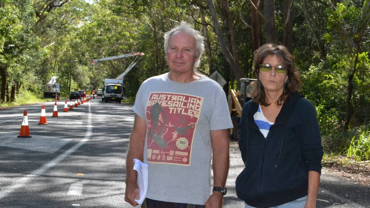 SAD: President of the Gerroa Environmental Protection Society Warren Holder and Debra Moore of the Concerned Residents Group of Gerringong look disappointed as the clearing work starts north of the Beach Road intersection on Gerroa Road on Thursday morning.