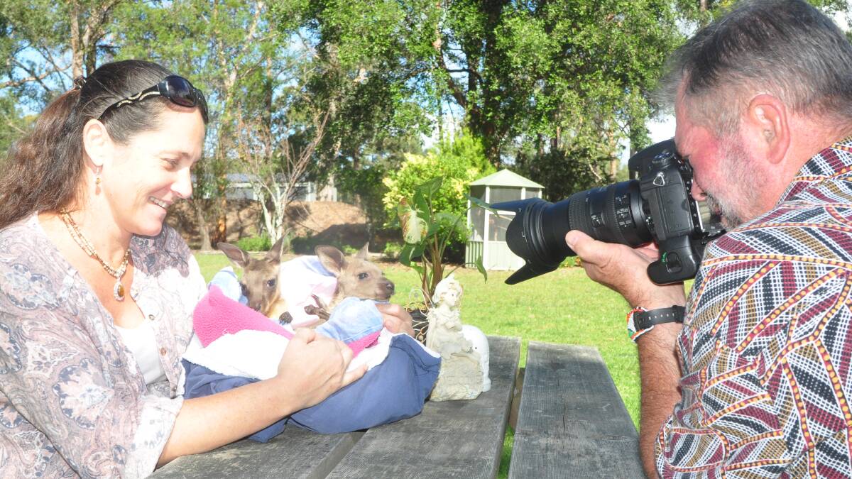 TOO CUTE: Warren Wilson photographs Wildlife Rescue South Coast volunteer Belinda Gales with two orphaned joeys.