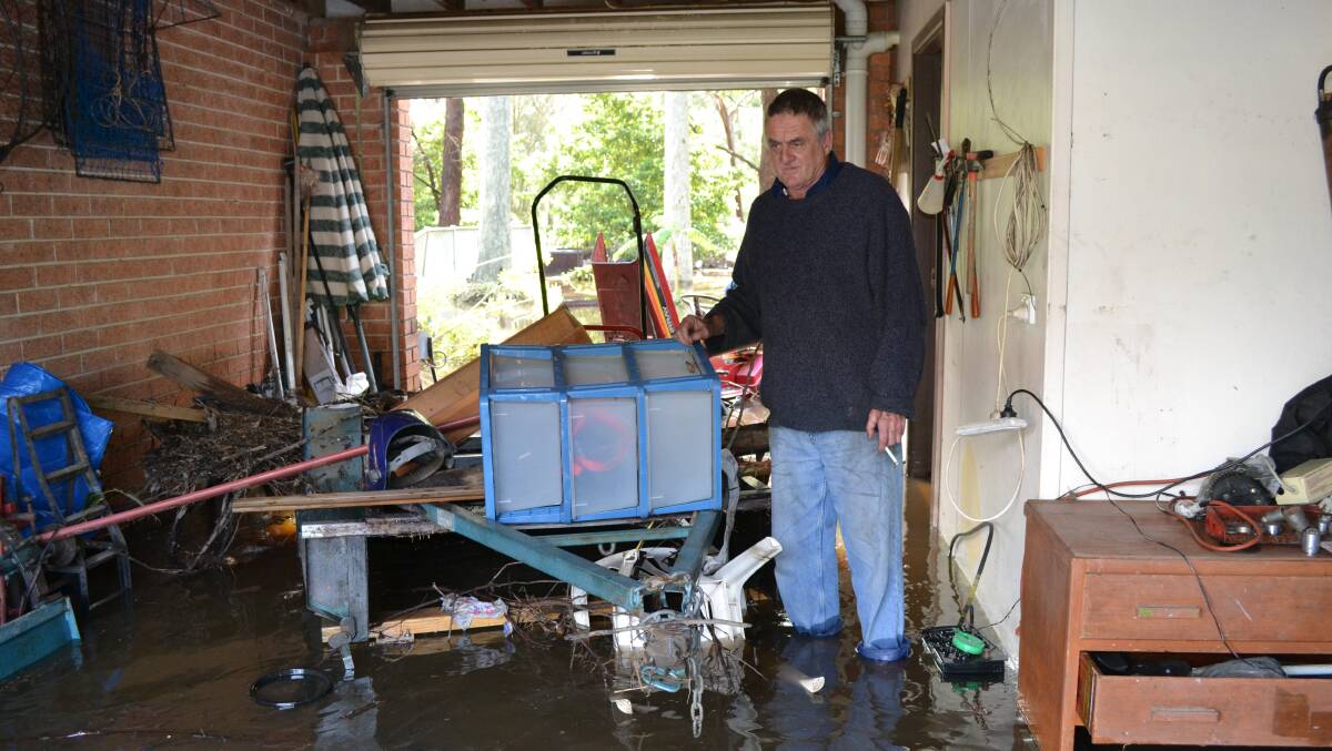 WATERLOGGED: The Park Drive resident Jim Page surveys the damage to his lower storey garage at Sanctuary Point.