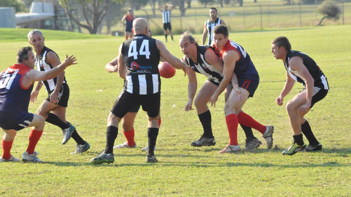 SCRAMBLE: It's a tough game for the Albatross Demons, as they scramble for possession against Port Kembla.