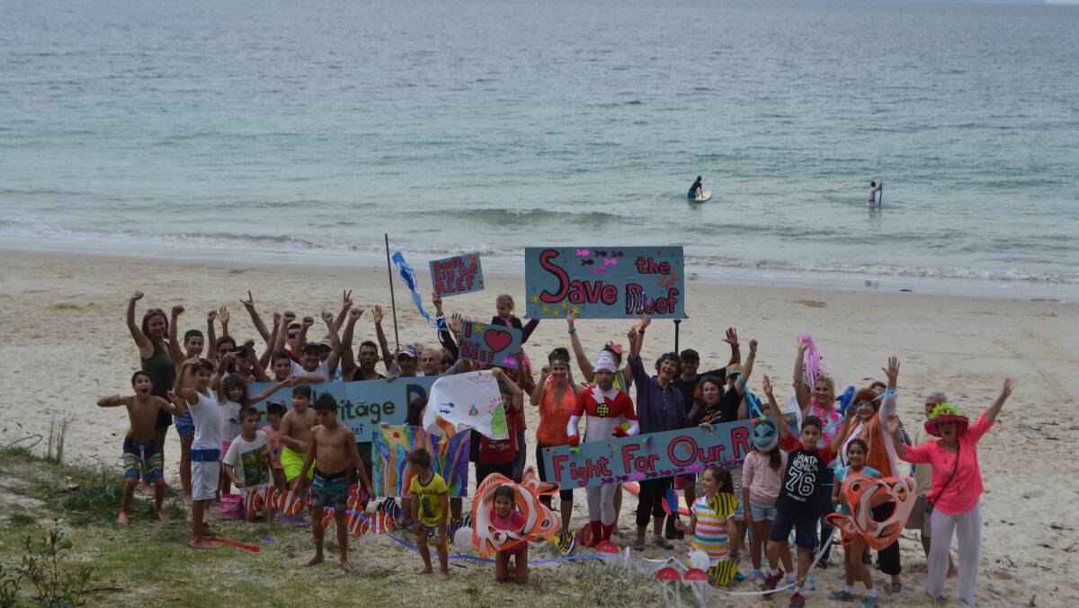 STAND: A large group of supporters congregates on Huskisson Beach on Saturday for World Heritage Day’s Fight for the Reef campaign.