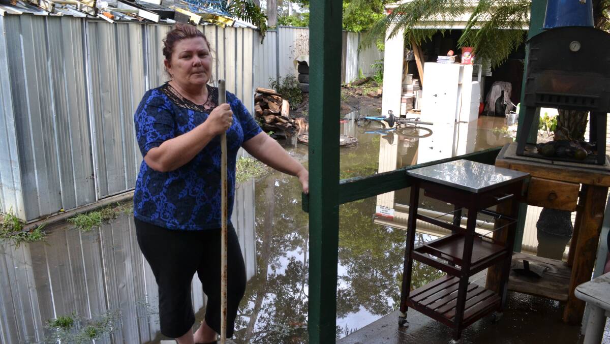 BIG JOB: Sanctuary Point woman Amanda Doyle surveys the damage to her home and flooded backyard at The Park Drive.
