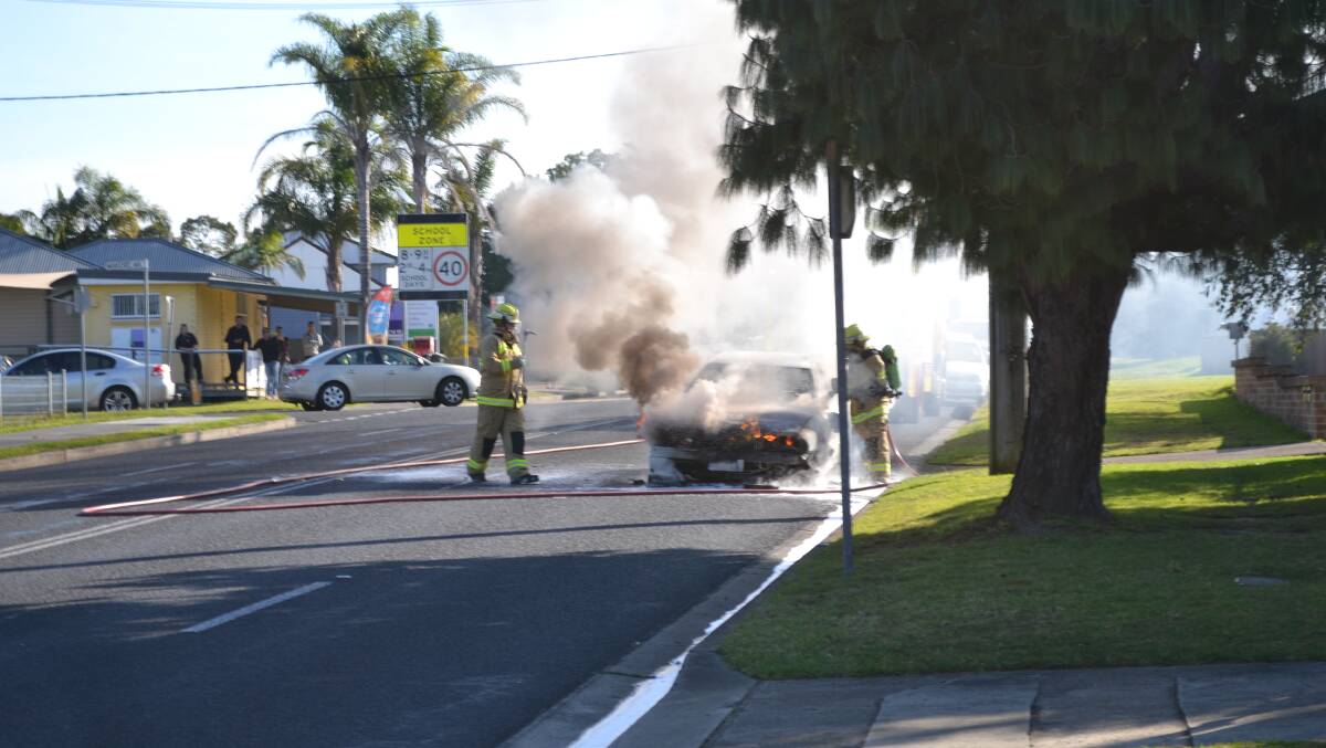 BLAZE: Fire and rescue NSW Shoalhaven crews extinguish a Mitsubishi sedan which caught fire on Friday afternoon.