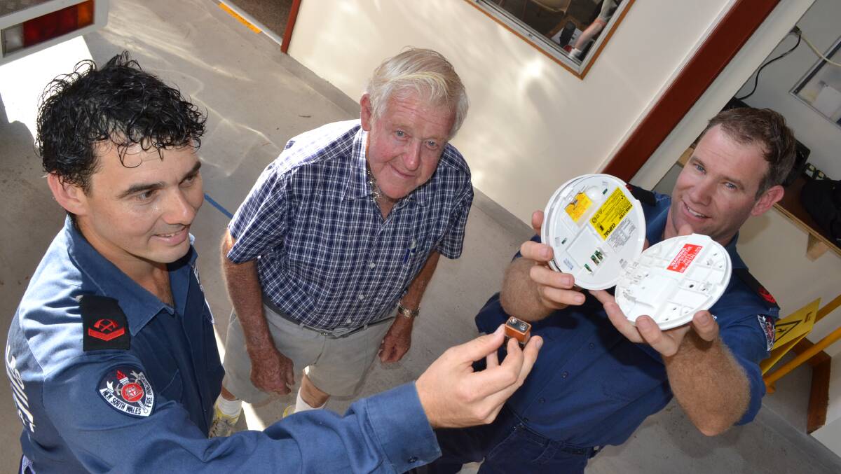 ALARMED: Fire and Rescue NSW Berry firefighters Luke (left) and Aaron Bramley (right) discuss the Change your clock, change your smoke alarm battery campaign with Luke’s grandfather and retired firefighter Bill Bramley.