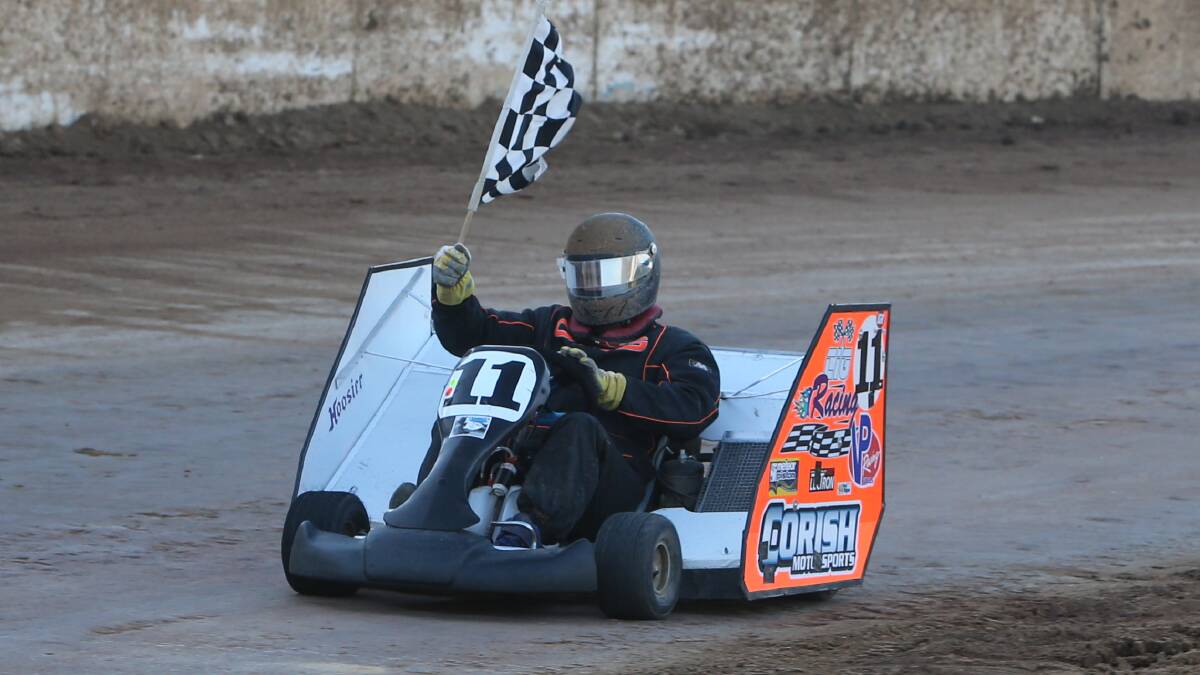 VICTORY: 2014 Victorian Speedway Kart Titles 200cc Kart winner Brandon Corish waves the chequered flag.