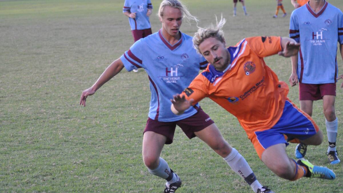 HAMMER TIME: Culburra striker Corey Ryan takes a bit of a tumble after a challenge with Heads defender Jye Findlay during his return from injury on Saturday. Photo: PATRICK FAHY