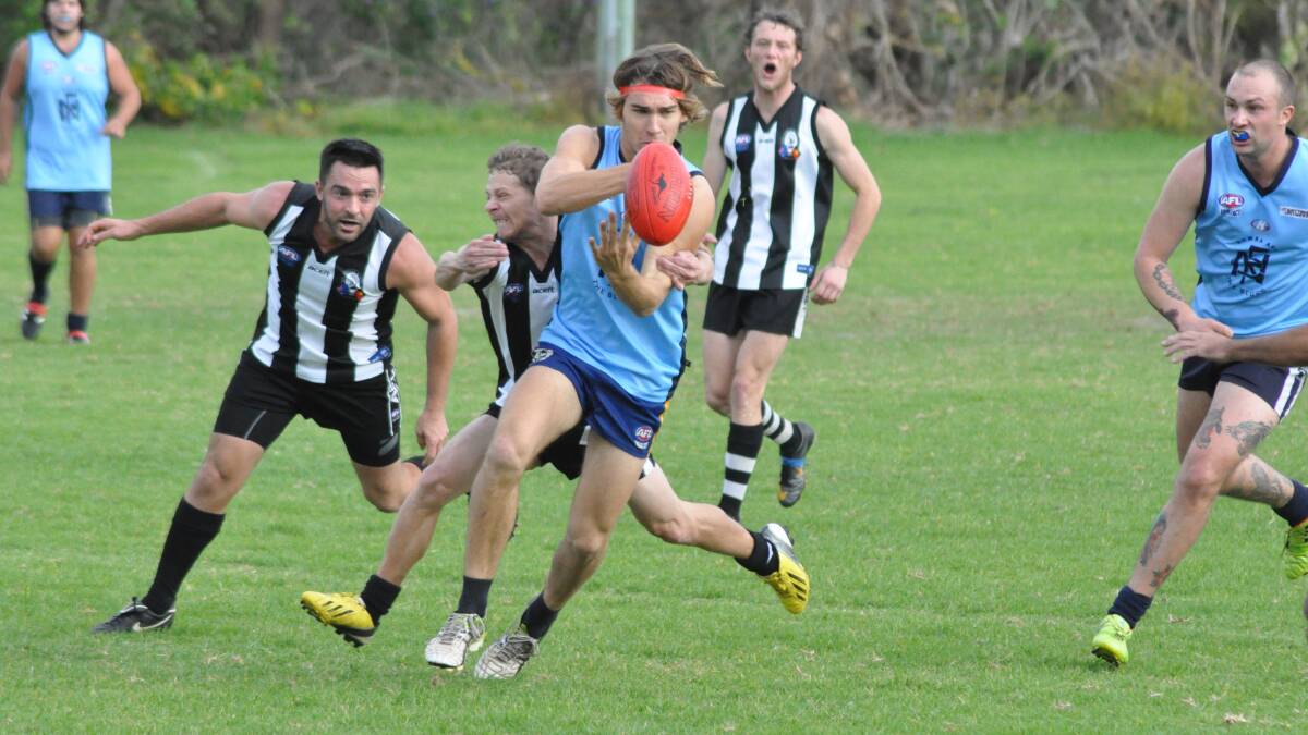 QUICK HANDS: Nowra Blues’ Vincent Barwick attempts to stay out of trouble with a hand ball. Photo: PATRICK FAHY