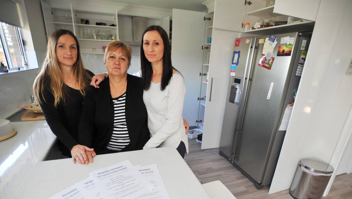 Carmel Norton, centre, with daughters Brooke and Megan, has called for assistance to locate her late husband's jewellery and other sentimental items stolen from the family home. Picture: Kieren L Tilly