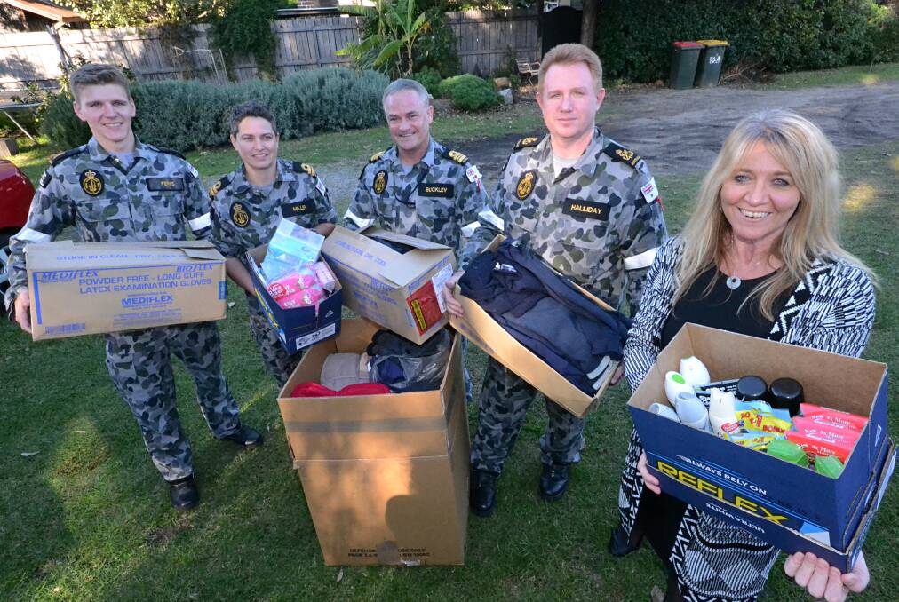 COMMUNITY SUPPORT: Jay Perks, Shanon Miller, Matthew Buckley, Shane Halliday and Shoalhaven Homeless Hub co-ordinator Julie Bugden with the boxes of clothes, other goods and money donated from the RAN. 