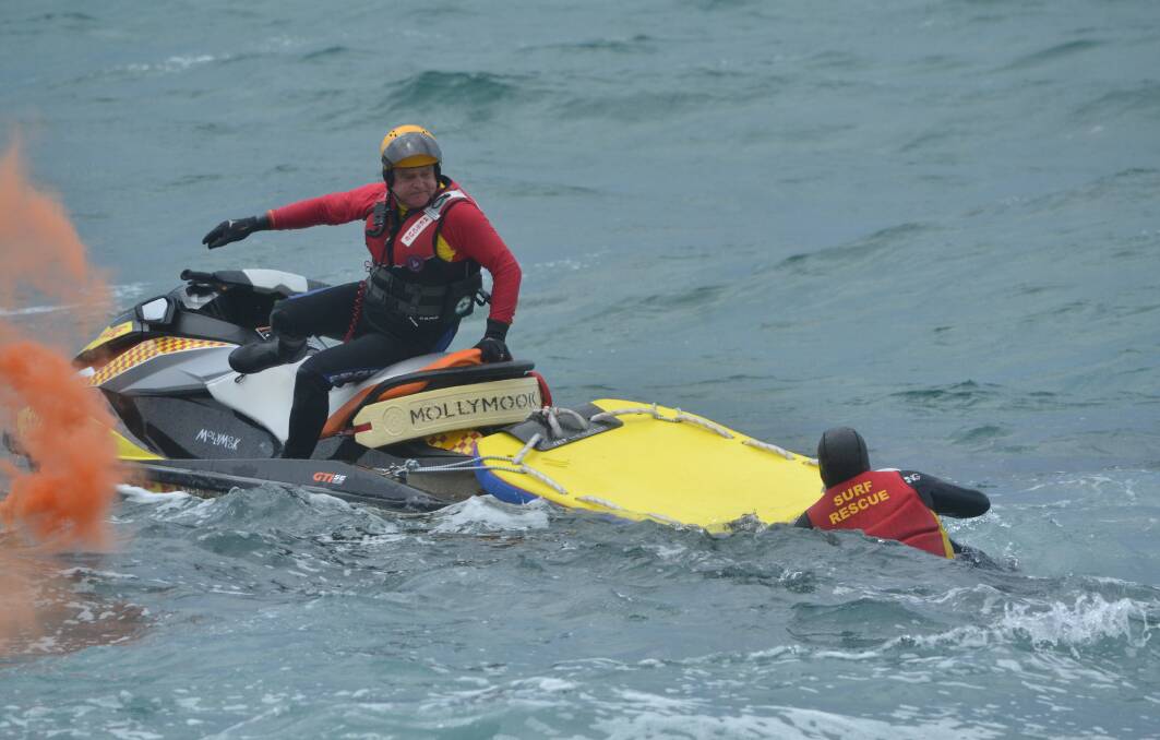 GRIM TASK: Surf lifesavers recover the body of a woman who drowned near Burrill Lake on November 5. 