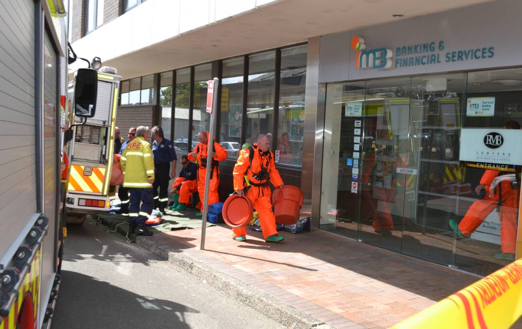 CAUTION: Fire and Rescue NSW personnel at RMB Lawyers in Nowra after it received a suspicious package.
