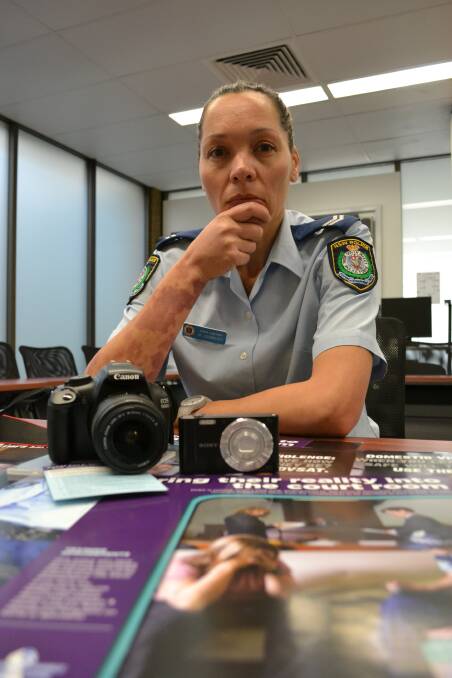 TELL US: Domestic violence liaison officer, Senior Constable Michelle Hammond of Shoalhaven Local Area Command, shows the unobtrusive video camera police are using to record victim statements, alongside a digital single lens reflex camera. 	Photo: ROBERT CRAWFORD