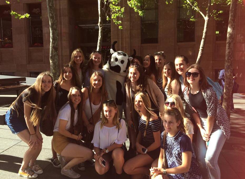 HAPPY SNAP: St John The Evangelist High School students pose for a photo with the Sunrise Cash Cow moments before the Martin Place siege began.