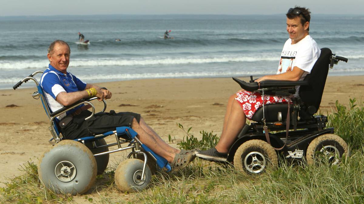 MOBILE: Jim Bradley, from the Disabled Surfing Association, with Andy Farrell after taking delivery of a new beach wheelchair. 	Photo: KIRK GILMOUR
