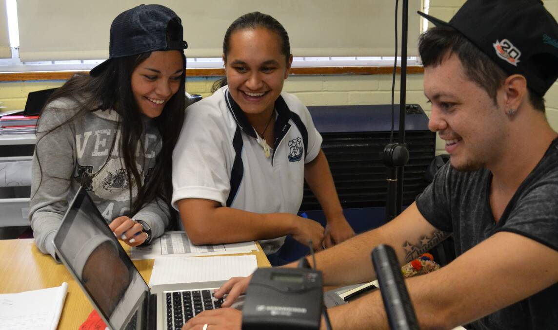 CHASING DREAMS: Nowra High School students Jacol Hardy and Jenayha Helmons work with rapper Corey Webster on a song during his visit to the school on Thursday. 