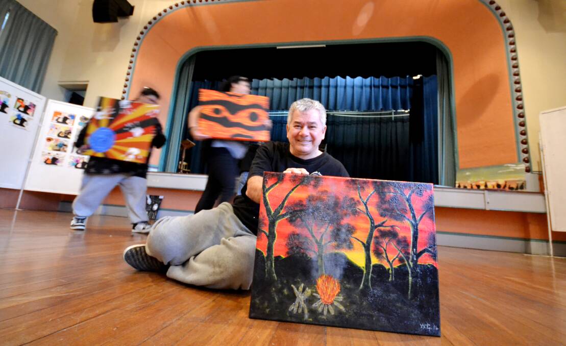 BLACK COCKATOO COLLECTION: Wayne Graham from Nowra with his painting titled Campfire will be among the large selection of Aboriginal artists’ works on display in the Nowra School of Arts this week. 	Photo ADAM WRIGHT