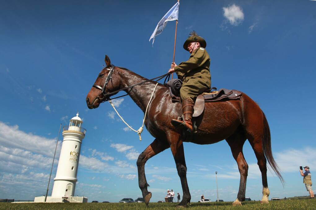 ICONS: Kiama-Jamberoo RSL’s member and Light Horse rider Lindsay Delamont in front of the Kiama Lighthouse, sporting its new Centenary of Anzac logo.