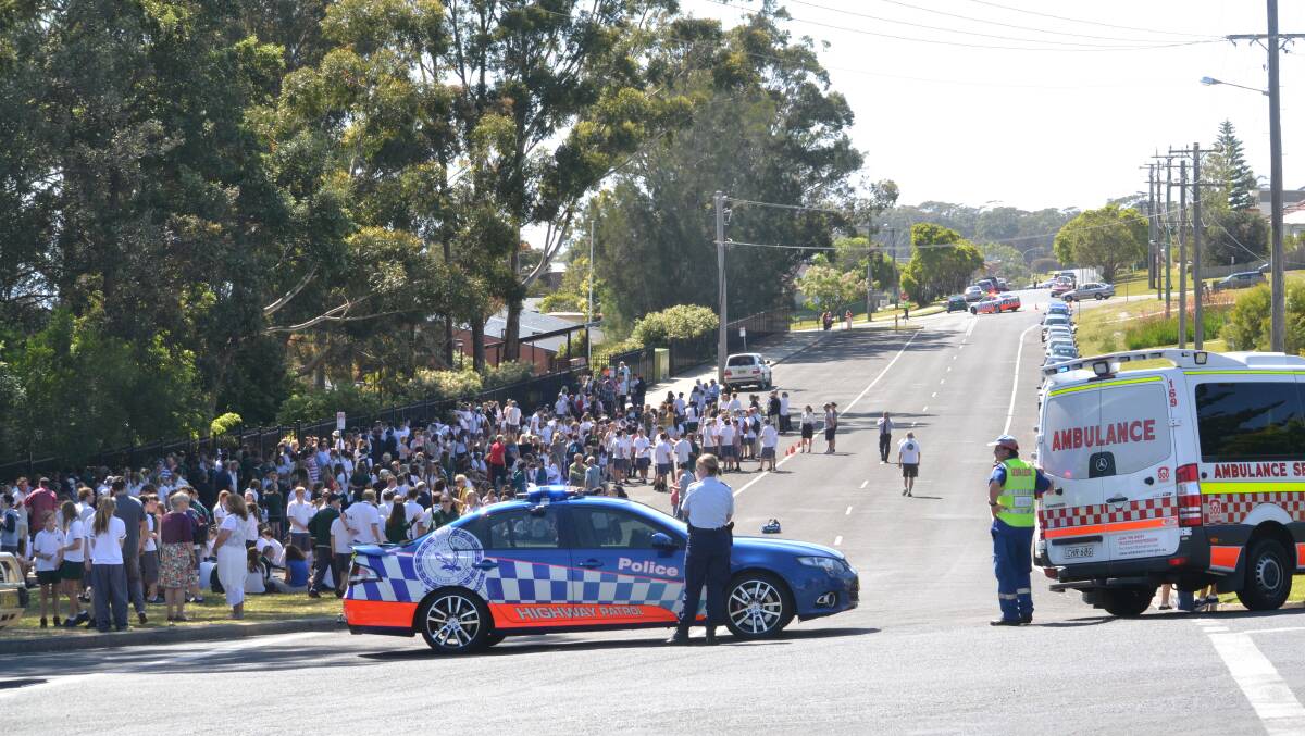 SCHOOL’S OUT: Ulladulla High School students sit out the gas leak on Thursday morning.
