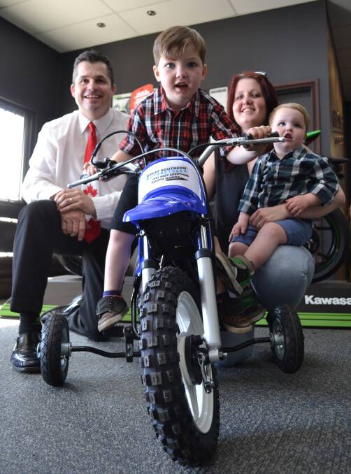 SPIN OUT: Greg Turner from Maple Leaf Realty who helped raise donations toward a new bike for Isaac Cullen, after it was stolen, lights up when he sees Isaac is ready to put those new wheels to the test with his little brother Evan and mother Michala Towne from Nowra at Great Southern Motorcycles.