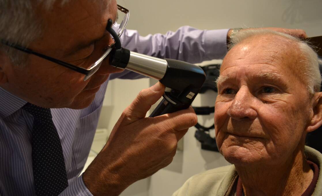 MACULAR CHECK: Nowra optometrist Peter Rose checks Sussex Inlets Ray Watchorn’s eyes for macular degeneration during Macular Degeneration Awareness Week.