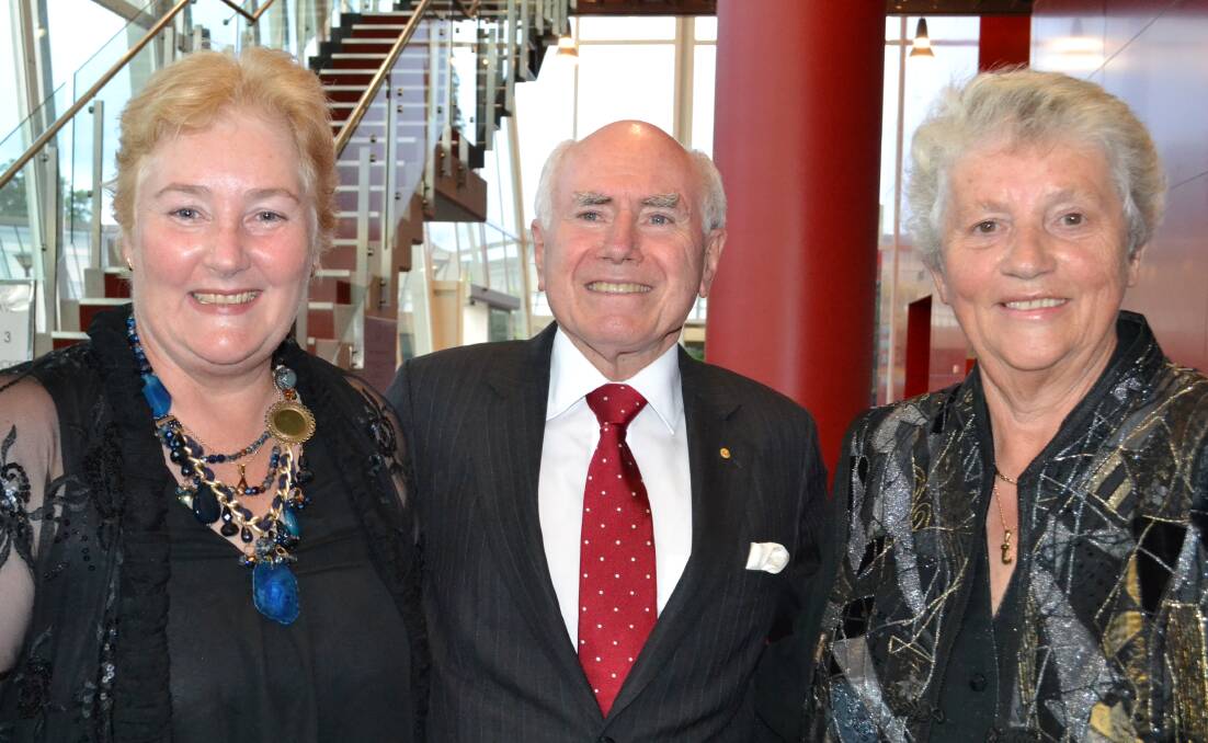 VALEDICTORY: Gilmore MP Ann Sudmalis and former Prime Minister John Howard celebrate Joanna Gash’s 17 years of service at an honorary dinner at the Shoalhaven Entertainment Centre on Thursday night.