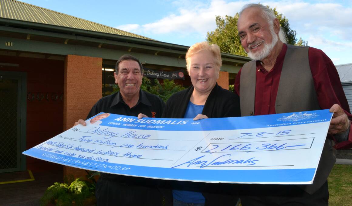 GOOD WORK: Gilmore MP Ann Sudmalis presents more than $2 million in funding to Oolong chief executive officer Ivern Ardler and local elder Uncle Darren McLeod.