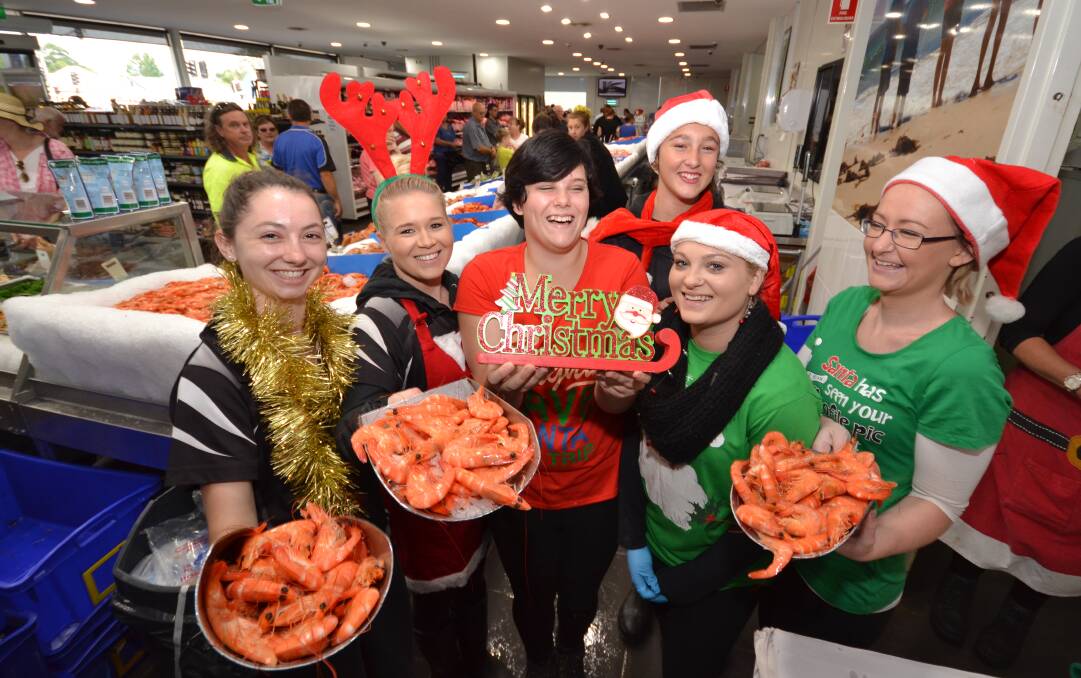 FLAT CHAT: Brielle Musgrove, Sallee Webster, Carissa Logue, Chanice Banks, Maddy Griffiths and Elley Smith serve up the seafood in what is Nowra Fresh Fish and Meat Market’s craziest time of the year.