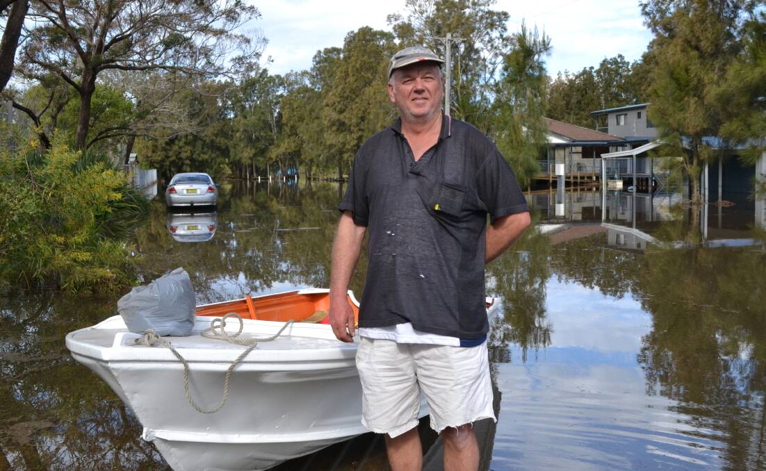 NEIGHBOURLY: Badgee resident Gary Phillis used his boat to check on his flood-stricken neighbours.
