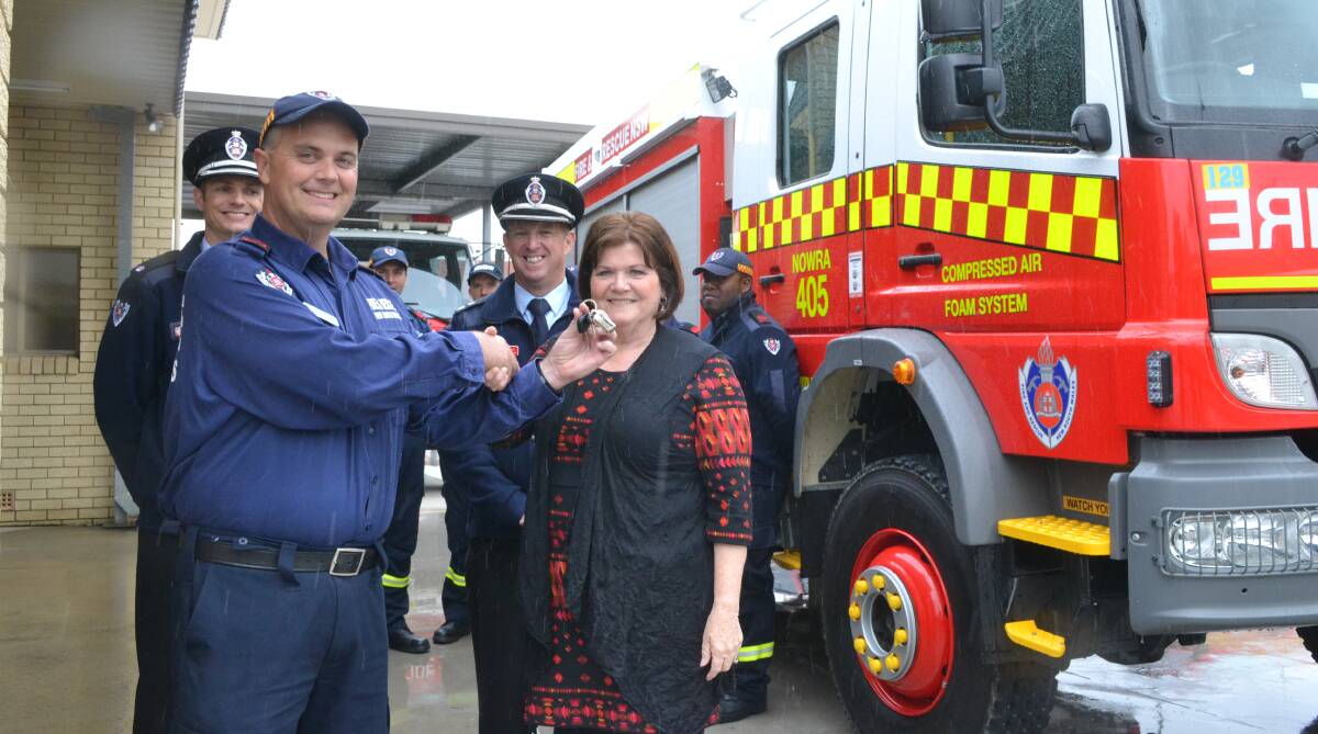 HANDOVER: South Coast MP Shelley Hancock presents the keys to the new $465,000 Compressed Air Foam System (CAFS) firefighting tanker to Nowra captain John Dun with Duty Commander Monaro Inspector Luke Unsworth and Batemans Bay Zone Commander Superintendent David Lewis.