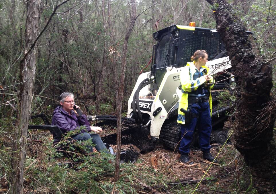 PEOPLE POWER: Cr Amanda Findley stops machinery from clearing bush on waterfront land at Callala Beach.