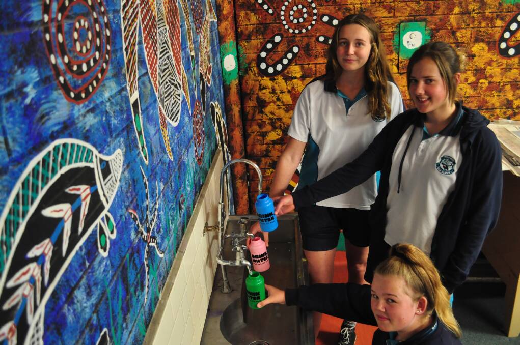 QUENCHED: Shoalhaven High School year 9 students Rose Hughes, Taylor Kerr and Cody Hession fill up their new drink bottles. Photo: COURTNEY WARD