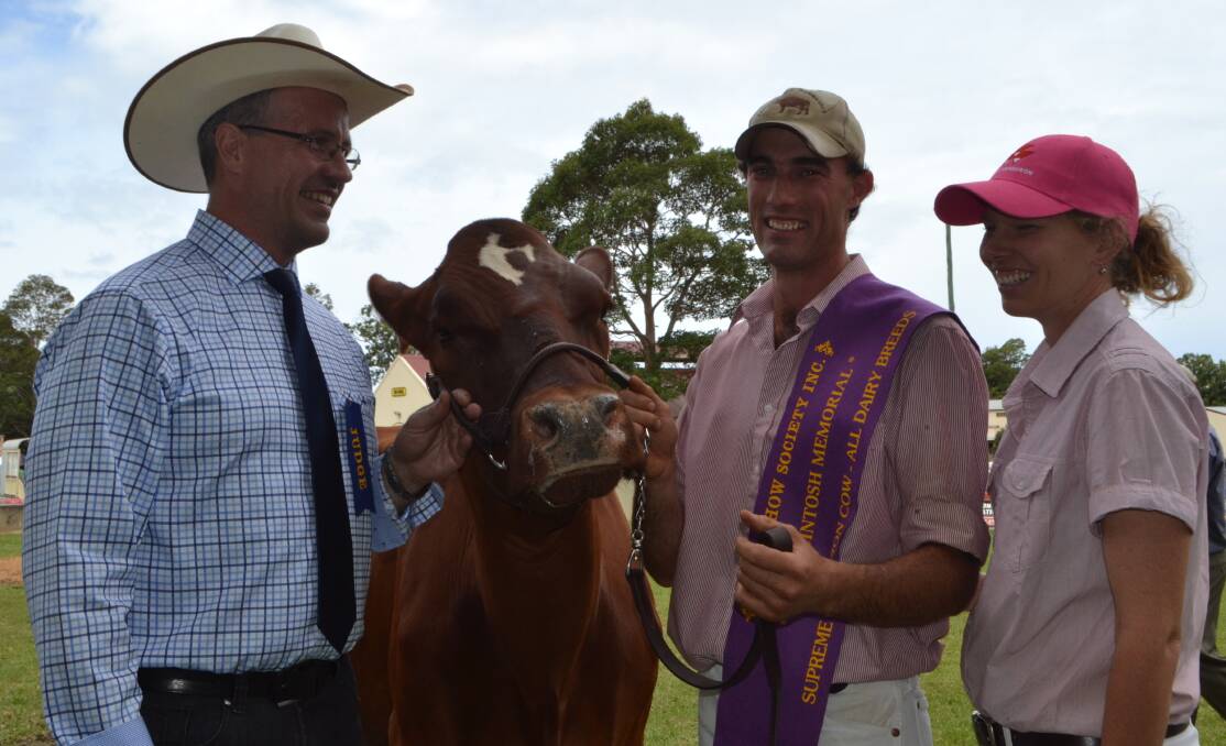 GREAT TIME: Visiting Canadian judge Jamie Wood congratulates Tom and Kyleigh Cochrane, of Pyree, on winning the supreme dairy cow and the FA McIntosh Memorial Trophy with four-year-old Illawarra, Kangawarra Stella 3713, at this year’s Berry Show.