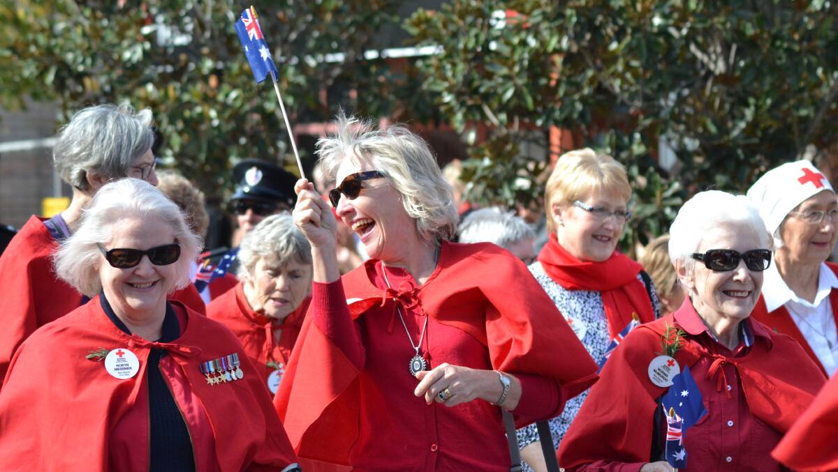 VOLUNTEERS: Members of the Berry Red Cross Robyn Messner, Felicity Coughlan and Norma McMurdo among their fellow volunteers at the 2014 Berry Anzac Day march. The Red Cross celebrates 100 years in Australia this year. 	Photo DAYLE LATHAM.