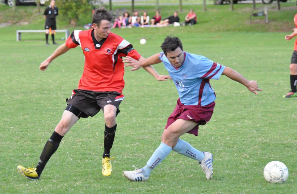 ARM WRESTLE: Shoalhaven United’s Dane Atkinson and Raffa Lombard from Shoalhaven Heads fight it out for the ball during Saturday’s clash at Lyrebird Park. 	Photo: PATRICK FAHY 