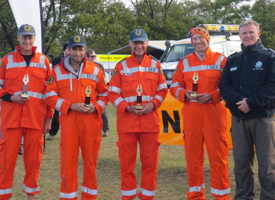 WAYFARERS: Nowra SES Team 1 (from left) Brad Davis, Geoff Young, Cliff Harris, and Scott Wells presented awards for finishing second overall and taking out the SES service category of the 2014 Navshield for the 14th straight year, by commander of the State Protection Group Chief Superintendent John Stapleton.