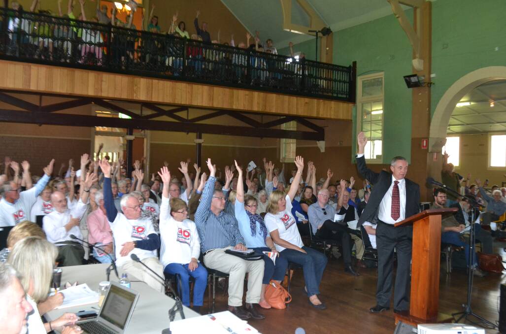 SHOW OF HANDS: Ralph Stadus asks the crowd at the Joint Regional Planning Panel public meeting in Berry on Thursday afternoon about a $13.6 million tourist and function centre, to raise their hands if they had had a “close call” while travelling on Kangaroo Valley Road.