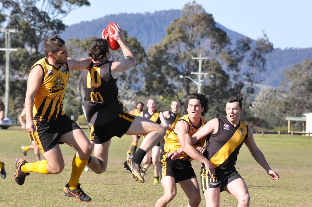 BIG MAN FLY: The Bomaderry and Northern Districts players fight for the ball. Photo DAMIAN McGILL