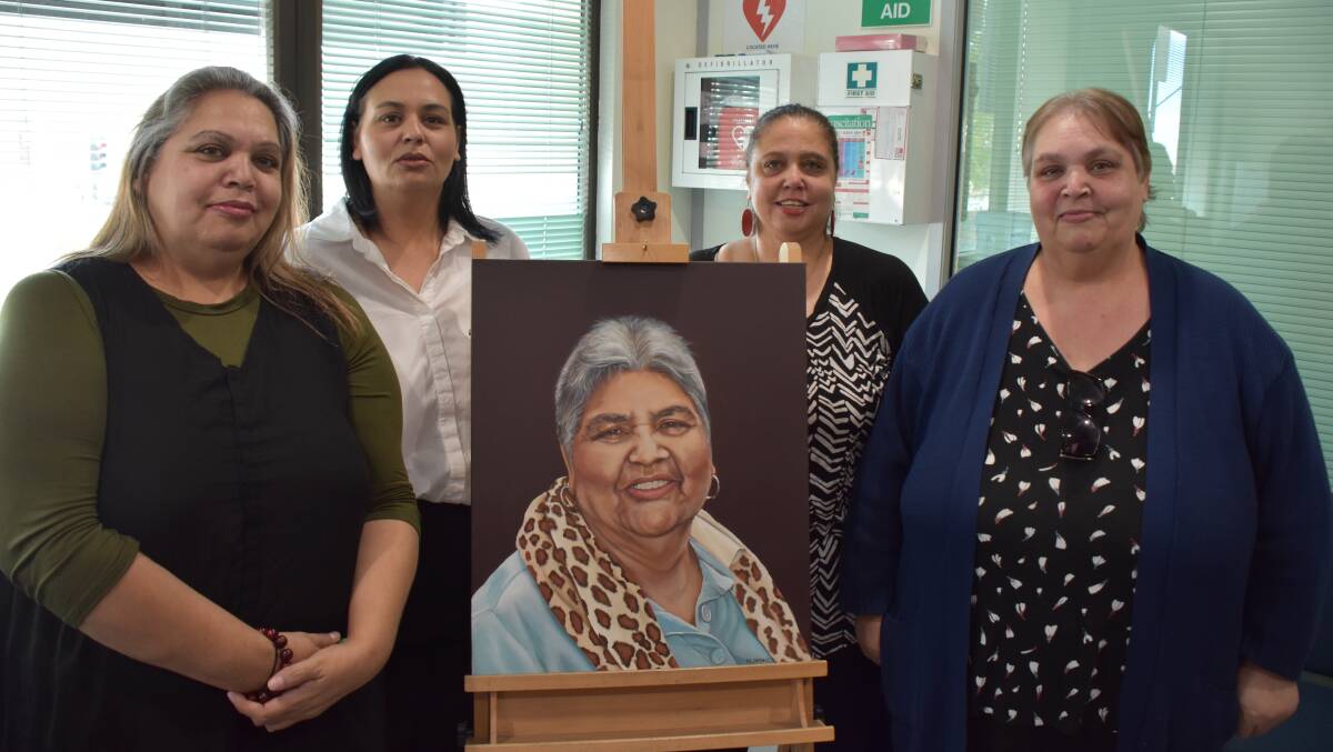 DELIGHTED: Aunty Barb Sutton's daughters, Marcia Sutton, Charmaine Bodini, Georgina Livesay and Terri Sutton with the stunning portrait of their mother which has been unveiled at the Juvenile Justice Centre in Nowra.