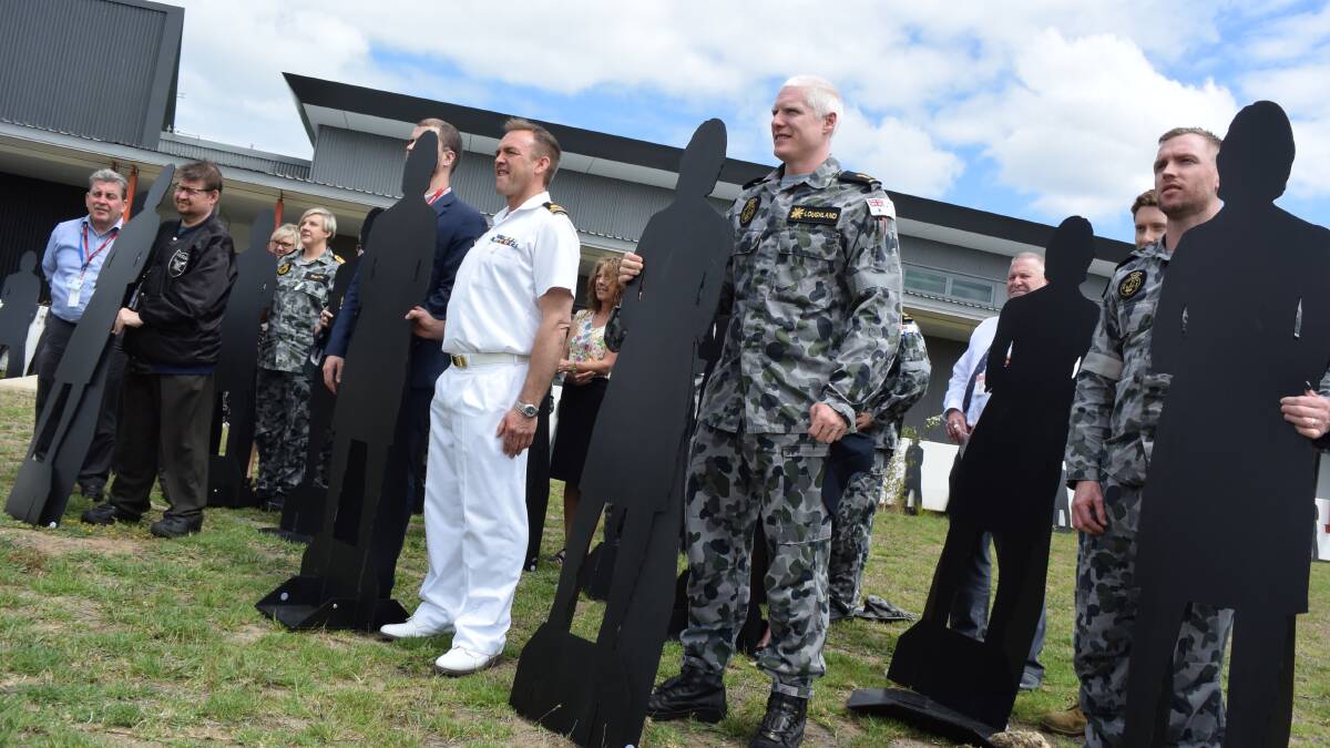 Lieutenant, Peter Kenworthy leads the White Ribbon oath, which was held outside near 52 silhouettes of women, representing the women who die each year from domestic abuse.