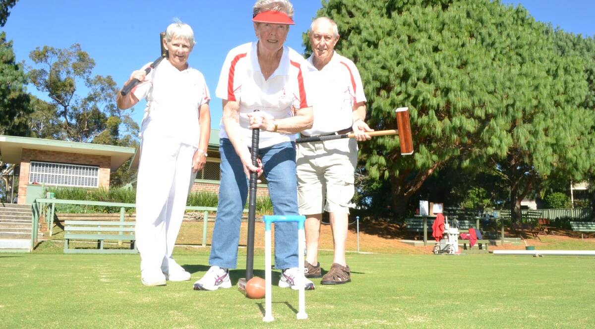 ON LINE: Nowra Croquet Club captain Margaret Sawers and publicity officer Bob Williamson watch as president Wendy Wade plays a hoop. 