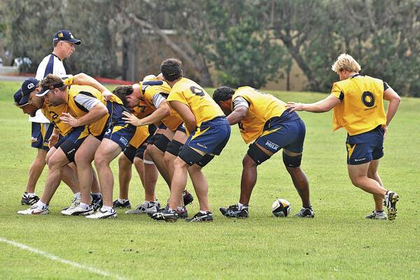 WORK OUT: ACT Brumbies coach Andy Friend keeps a watchful eye on his forward pack during the Creswell camp.Photos: DEAN WRIGHT