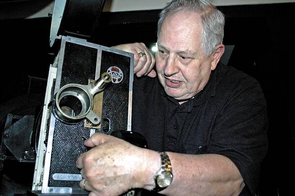PROJECTION: Bob Brainwood with the Roxy Cinema’s original projector from when the cinema opened 75 years ago.