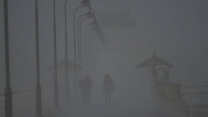 WeaDramatic weather on St Kilda Pier at 3.42pm Thursday afternoon. Photo: Joe Armao