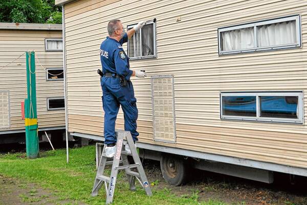 CRIME SCENE: Police gather evidence from the scene of the February 26 shooting at the Willows caravan park. 