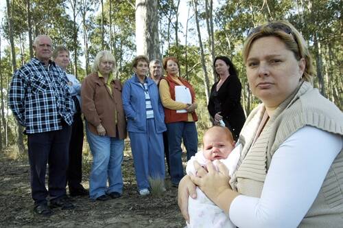 BUSHWACKED: Afraid of losing their quiet street and perfect place to raise children are Katy Daniel with daughter Emmi, joined by other Golden Grove residents Alby Barker, David and Suzy Murphy, Bev Barker, Terry and Sue Earle and Sam Purcell.
