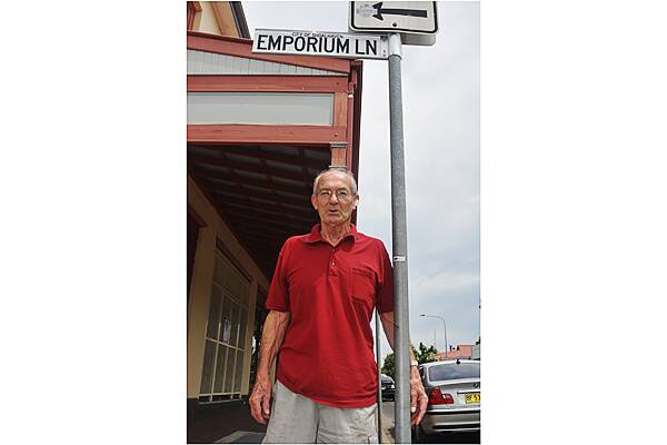 LANE TO REMEMBER: Keith Paterson, from the Nowra Historical Society with the Emporium Lane sign.
