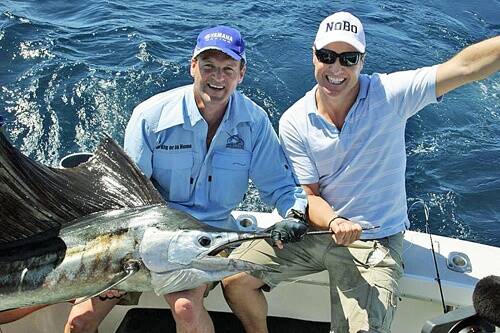 SAIL OF THE CENTURY:  Rob helps Ed Phillips hold up his first sailfish.