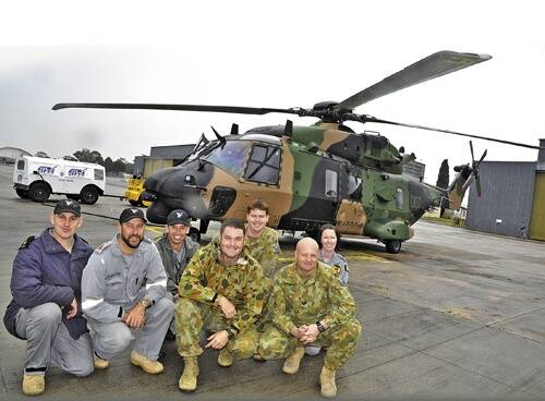 FRONTLINE: The MRH90 maintenance crew in front of one of two MRH90s delivered to HMAS Albatross on Wednesday - Richard Crouch, Chris Hagedoorn, Will McConnell, Glenn Wittig, Christopher Payne, Geoff Haynes and Josephine Melville.